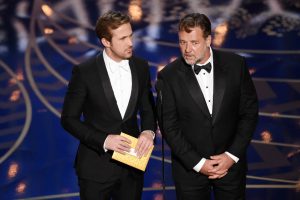 HOLLYWOOD, CA - FEBRUARY 28:  Actors Ryan Gosling (L) and Russell Crowe speak onstage during the 88th Annual Academy Awards at the Dolby Theatre on February 28, 2016 in Hollywood, California.  (Photo by Kevin Winter/Getty Images)