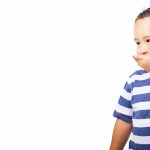 child covering his mouth on a white background