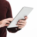 Close up portrait of a man using tablet computer
