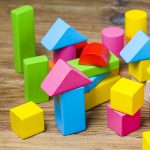 Building blocks on wooden background，Colorful wooden building