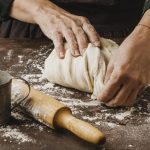 female-cook-kneading-pizza-dough