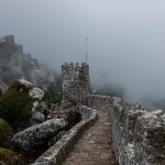 Historic castle of the Moors in Sintra, Portugal on a foggy day