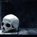 Human skull on wooden table